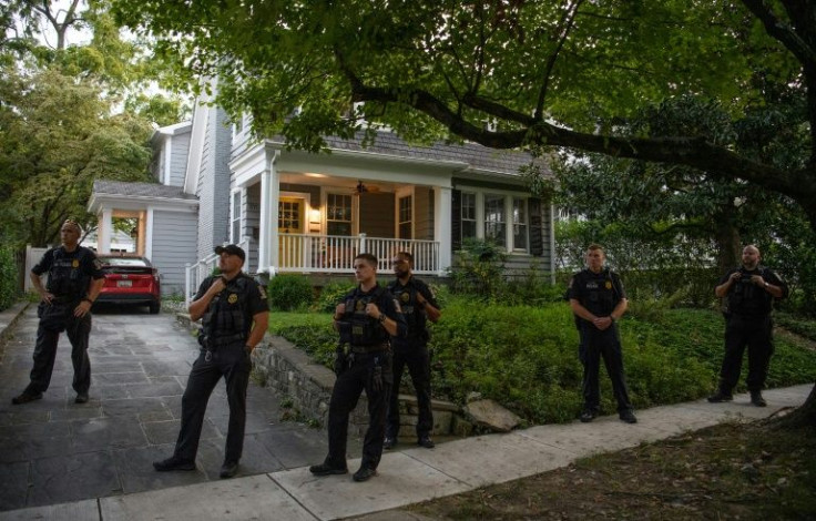 Police stand guard as abortion rights activists protest near the house of US Supreme Court Justice Brett Kavanaugh in Chevy Chase, Maryland in September 2021