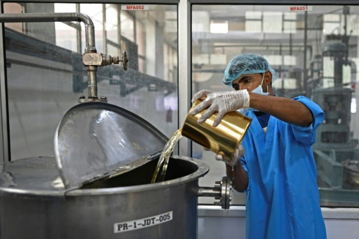 A worker adds an ingredient during the production of Rooh Afza at a factory in Manesar, India
