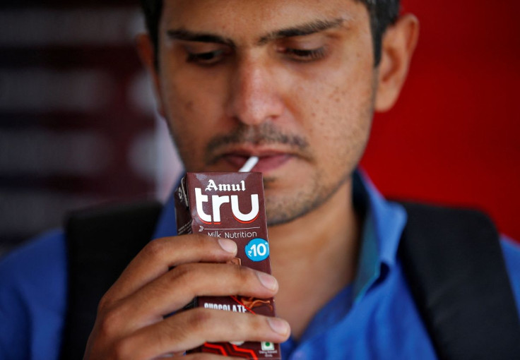 A man consumes Amul's chocolate flavoured drink outside an Amul cafe in Ahmedabad, India, June 8, 2022. 