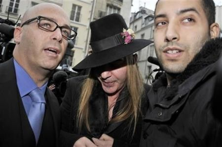 Fashion designer John Galliano (C) and his lawyer Stephane Zerbib (L) arrive for a hearing at a police station in Paris February 28, 2011.