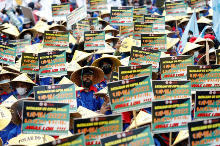 Members of Indonesian trade unions hold placards during a protest against the government's labor reforms, as Indonesia's Constitutional Court reads the verdict on a judicial review filed on the controversial 'omnibus' or job creation law in Jakarta, Indon