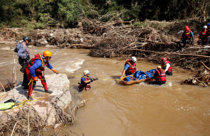 A search and rescue team prepares to airlift a body from the Mzinyathi River after heavy rains caused flooding near Durban, South Africa, April 19, 2022.
