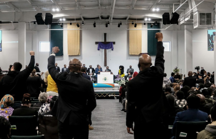 Mourners throw the Black Power Fist during the funeral of Patrick Lyoya, an unarmed Black man who was shot and killed by a Grand Rapids Police officer during a traffic stop on April 4, at Renaissance Church of God in Christ in Grand Rapids, Michigan, U.S.