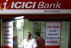 A man leaves an automated teller machine (ATM) facility of ICICI bank in Kochi
