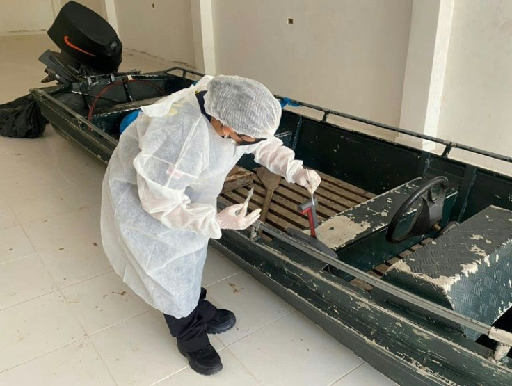 Forensics experts examin a boat after the disappearance of British Journalist Dom Philipps and Brazilian Indigenous expert Bruno Pereira