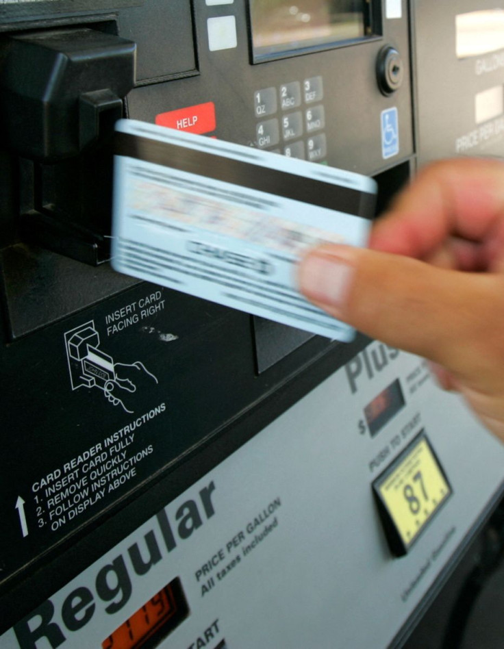 A customer swipes a credit card at a gas pump at a Phillips 66 gas station in Centennial, Colorado June 26, 2006. The gasoline at the station comes from the nearby Suncor Energy refinery. 