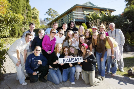 Fans pose in front of Australia's popular television show "Neighbours" set on the fictitious Ramsay Street, where Australian pop diva Kylie Minogue first found fame, at Pinoak Court in suburban Melbourne May 23, 2005. 