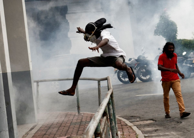 Demonstrators protest amidst tear gas used by the police to disperse them during a protest outside the Sri Lanka's police headquarters, amid the country's economic crisis, in Colombo, Sri Lanka, June 9, 2022. 
