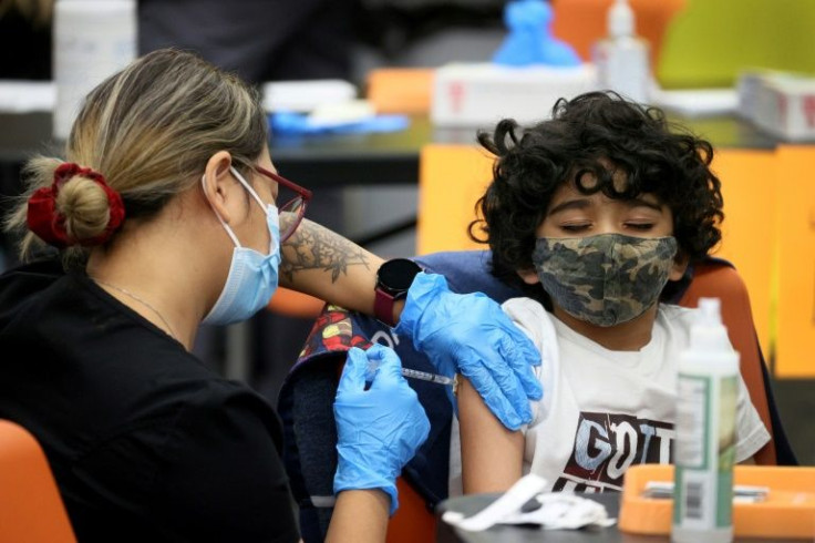 A 7-year-old child receives a Covid-19 vaccine in Chicago, Illinois
