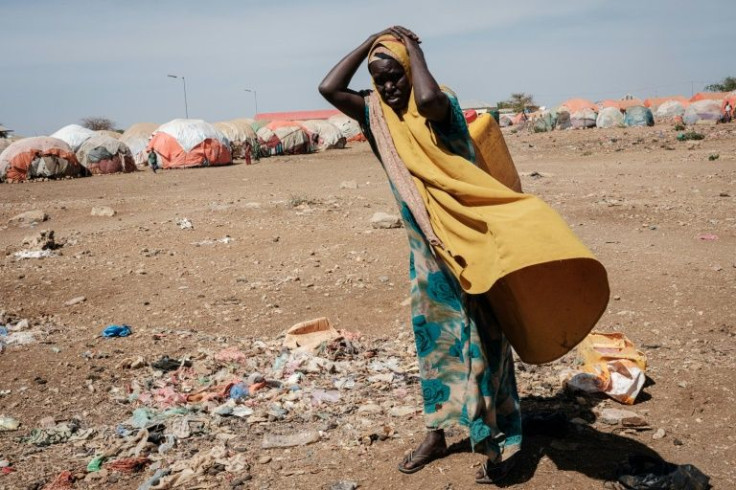 A woman carries a water container at a camp for displaced persons in Somalia. The country's years-long drought chimes with long-standing warnings about climate change