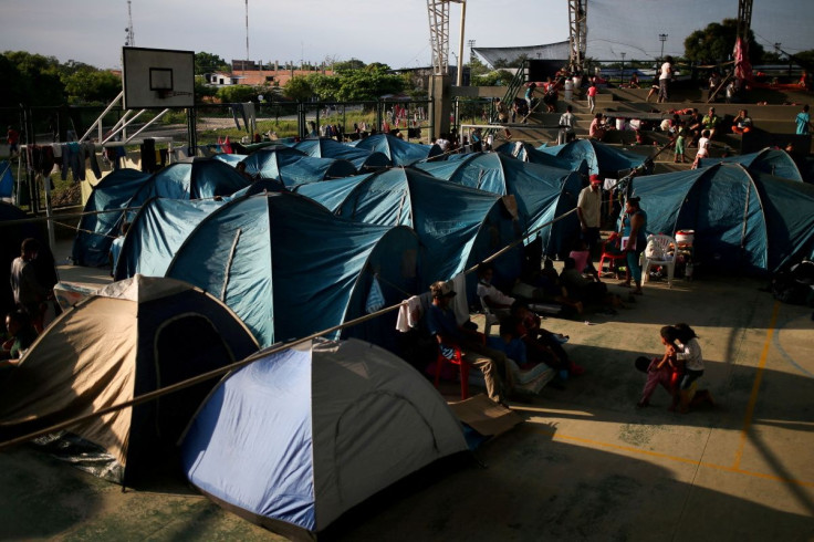 Venezuelan migrants are seen inside a coliseum where a temporary camp has been set up, after fleeing their country due to military operations, according to the Colombian migration agency, in Arauquita, Colombia March 27, 2021. 