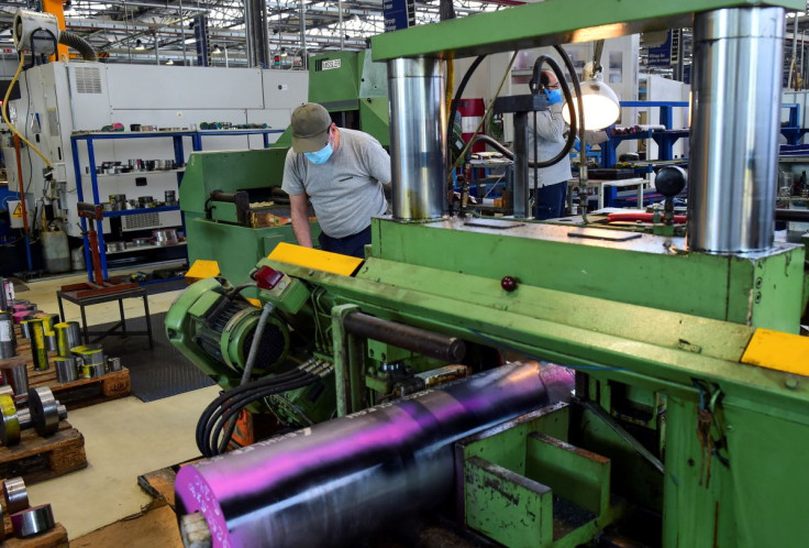 A worker at the Liebherr manufacturing company, which produces gear cutting tools, wears a protective mask as he works in the factory a day after its re-opened, as Italy begins a staged end to a nationwide lockdown due to a spread of the coronavirus disea