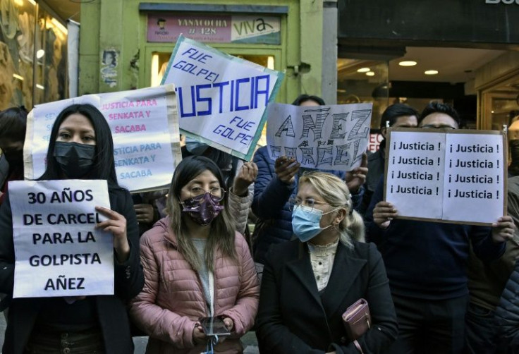 Opponents of Bolivian former interim President Jeanine Anez protest outside court during her trial in La Paz on June 7, 2022