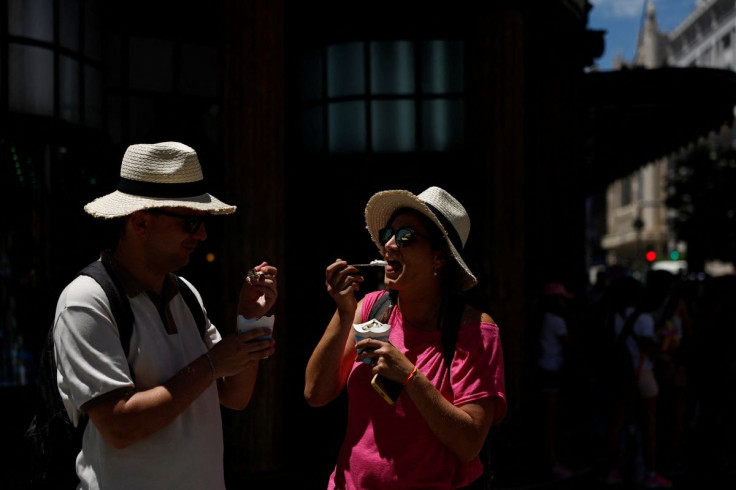 People eat ice cream on a hot day as Spain braces for a heatwave in Madrid, Spain, June 10, 2022. 