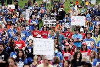 Demonstrators hold placards while participating in the 'March for Our Lives', one of a series of nationwide protests against gun violence, in Washington, DC, U.S., June 11, 2022. 