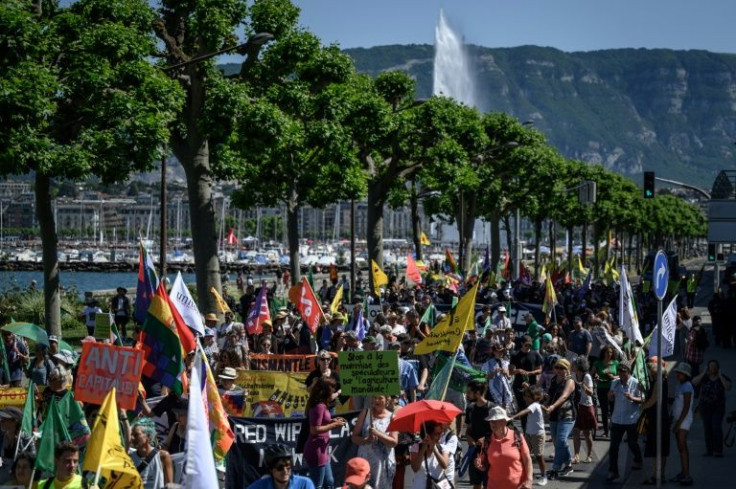Activists march during a protest against the World Trade Organization in Geneva