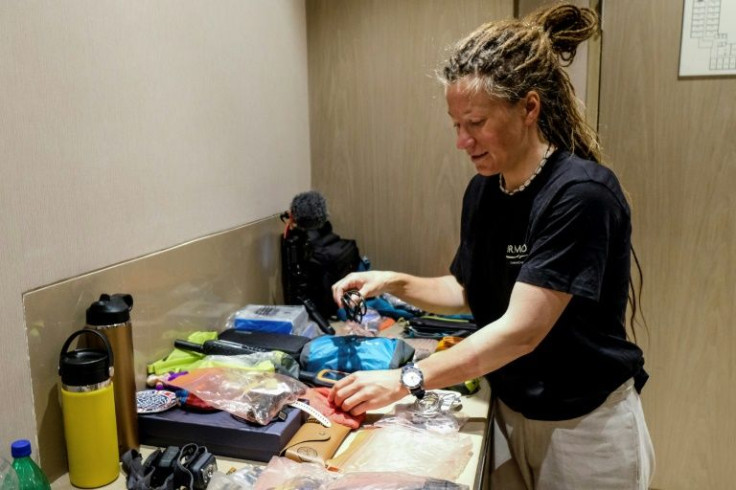 Norwegian mountaineer Kristin Harila arranges her equipment after an interview with AFP in Kathmandu.
