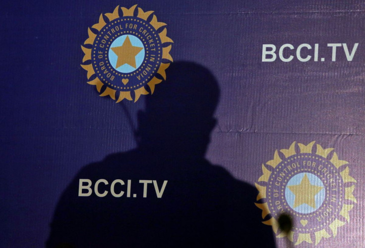 The shadow of a man falls on a backdrop with the logo of the India's cricket board BCCI before the start of a news conference to announce its cricket team's coach, in Mumbai, India, August 16, 2019.