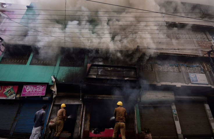 Firefighters try to douse a fire in a shop after violence erupted between police and protestors over a comment on Prophet Mohammed by Bharatiya Janata Party (BJP) member Nupur Sharma, in Howrah on the outskirts of Kolkata, India, June 11, 2022.