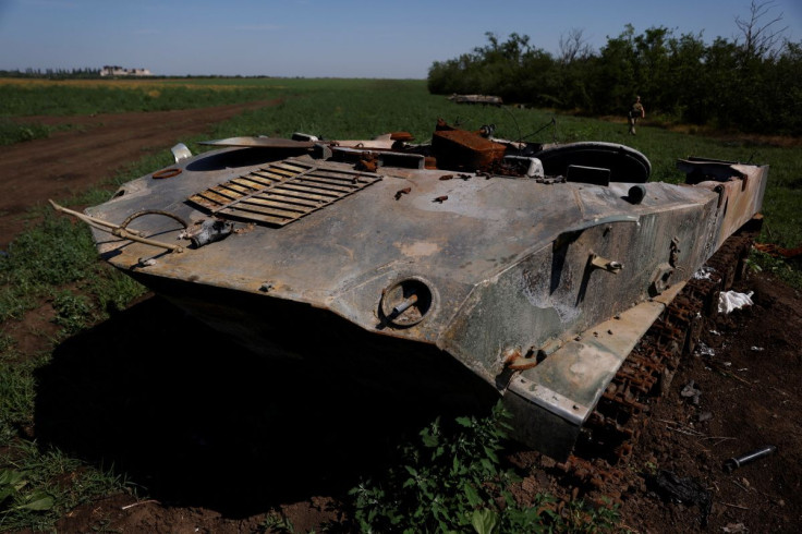 A Ukrainian soldier walks past destroyed Russian tanks in a field, as Russia's attacks on Ukraine continue, in Mykolaiv region, Ukraine June 12, 2022. 