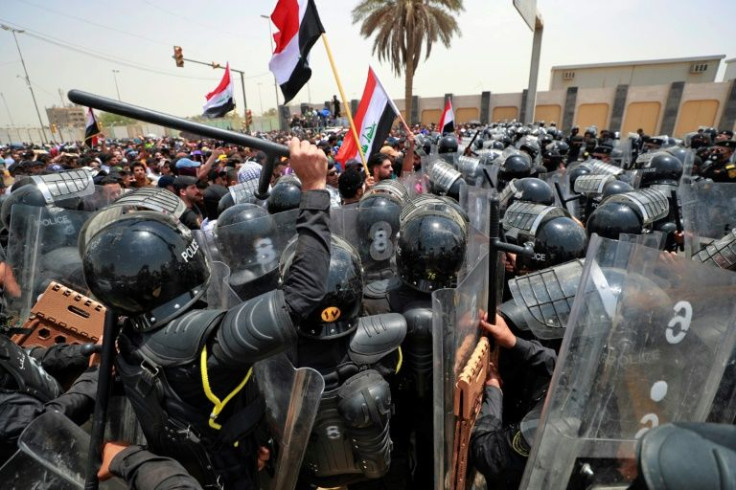 Iraqi security forces deploy to disperse protesters during a demonstration against the government's employment policy, near the parliament building in Baghdad's Green Zone on June 7, 2022