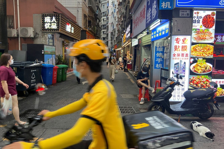 A food delivery worker rides past an urban village in Shenzhen's Futian district, Guangdong province, China May 31, 2022.  