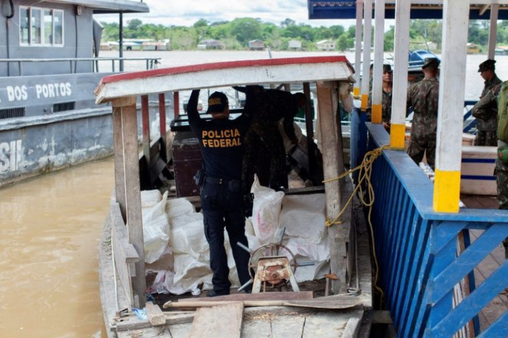 A Federal Police expert examines a boat seized by the Task Force for the rescue of Indigenist Bruno Pereira and Journalist Dom Phillips at the port of the city of Atalaia do Norte, Amazonas, Brazil, on June 11, 2022