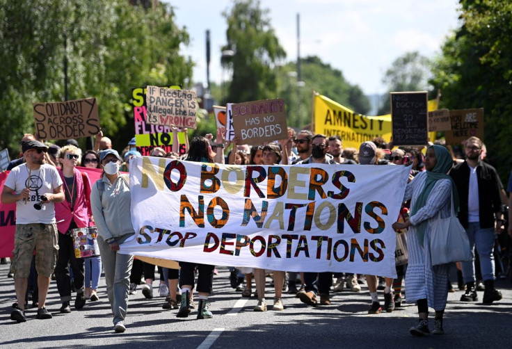 Demonstrators protest outside of an airport perimeter fence against a planned deportation of asylum seekers from Britain to Rwanda, at Gatwick Airport near Crawley, Britain, June 12, 2022. 