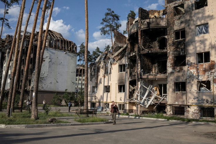 People look at destroyed buildings in Irpin, outside Kyiv, as Russia's attacks on Ukraine continues, June 9, 2022. 