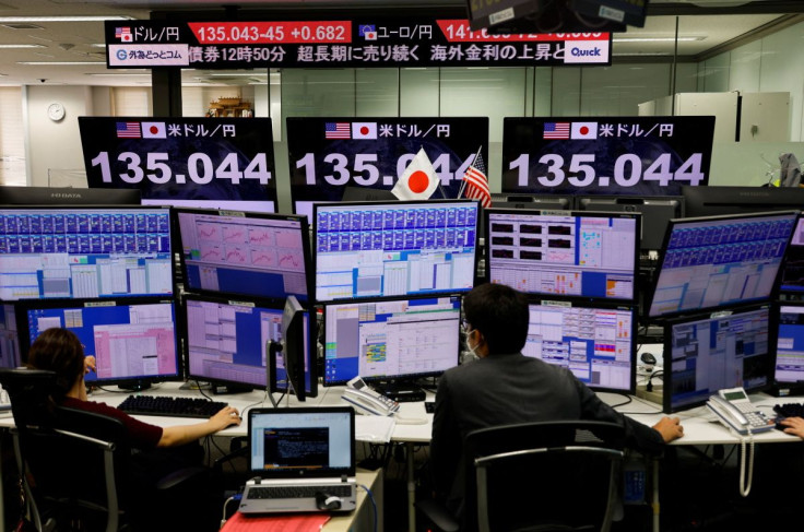Employees of the foreign exchange trading company Gaitame.com work in front of a monitor showing the Japanese yen exchange rate against the U.S. dollar at its dealing room in Tokyo, Japan June 13, 2022.  