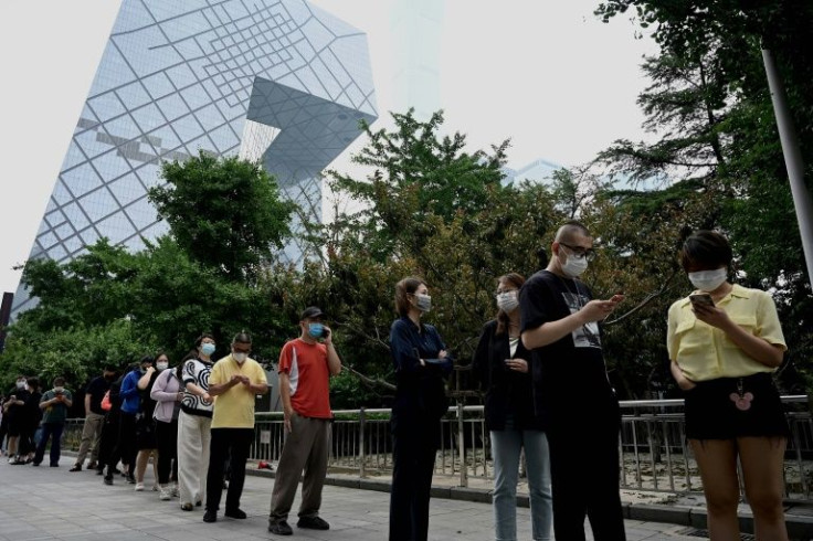 Beijing launched mass testing in its most populous downtown district after a rapidly spreading outbreak linked to a bar saw Covid rules tightened
