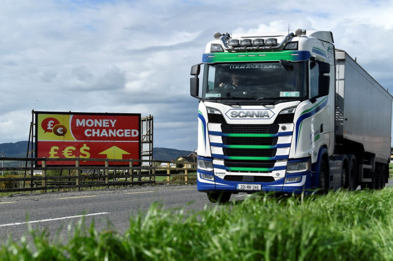 A truck drives past a 'money changed' sign for euro, sterling and dollar currencies on the border between Northern Ireland and Ireland, in Jonesborough, Northern Ireland, May 19, 2022. 