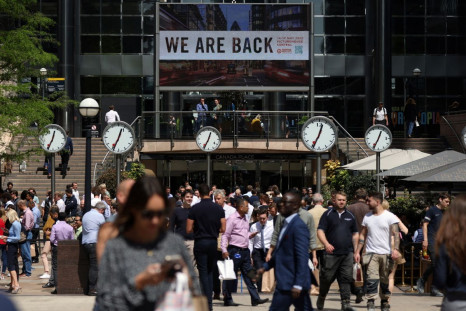 People walk through the financial district of Canary Wharf as it was announced that British consumer price inflation hit an annual rate of 9.0% in April, in London, Britain, May 18, 2022.     