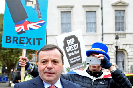 British businessman and co-founder of the Leave.EU campaign Arron Banks walks past anti-Brexit demonstrators outside the Houses of Parliament in London, Britain, March 27, 2019. 