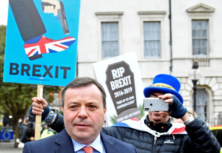 British businessman and co-founder of the Leave.EU campaign Arron Banks walks past anti-Brexit demonstrators outside the Houses of Parliament in London, Britain, March 27, 2019. 