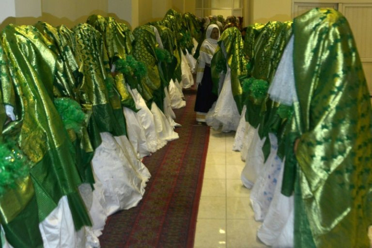 Brides line up inside a Kabul wedding hall as they wait for the start of the mass marriage ceremony