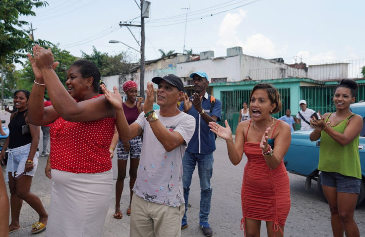 People react as Amelia Calzadilla (not pictured) walks back home after attending a meeting at the municipal assembly in Havana, Cuba, June 13, 2022. 