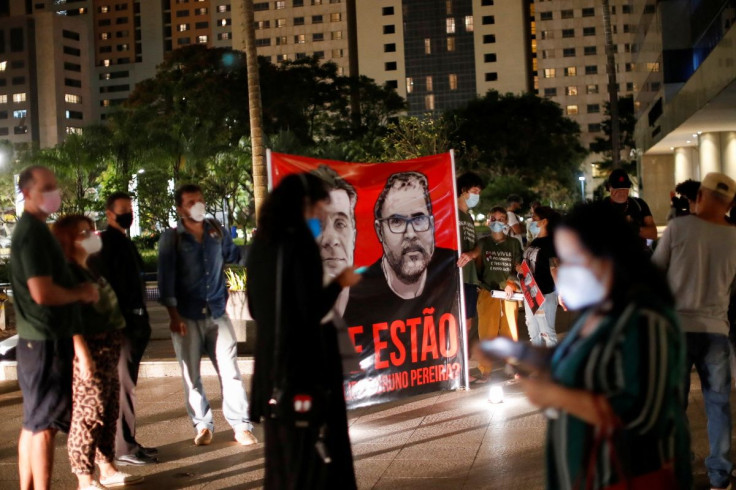 People hold a banner during a vigil following the disappearance of British journalist Dom Phillips and indigenous expert Bruno Pereira, who went missing while reporting in a remote and lawless part of the Amazon rainforest near the border with Peru, in fr