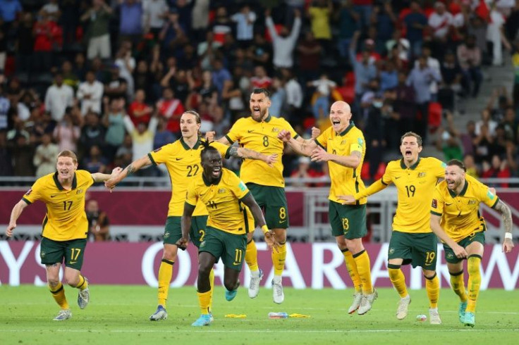 Australian players celebrate qualifying for the 2022 World Cup finals after beating Peru on penalties
