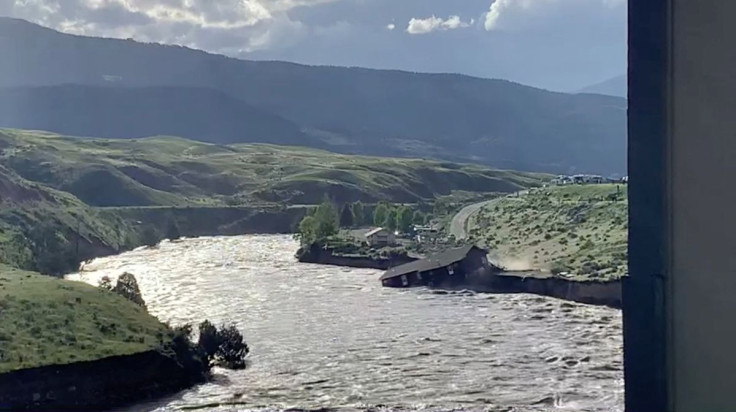 A house falls into the Yellowstone river due to flooding in Gardiner, Montana, U.S., June 13, 2022 in this screen grab obtained from a social media video. Angie Lilly/via REUTERS