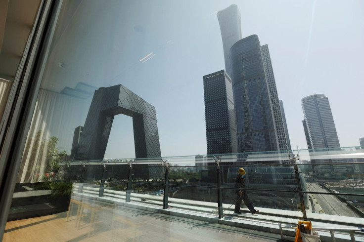 A cleaning worker is seen through a glass window at a shopping mall in the Central Business District (CBD), amid the coronavirus disease (COVID-19) outbreak in Beijing, China June 2, 2022.
