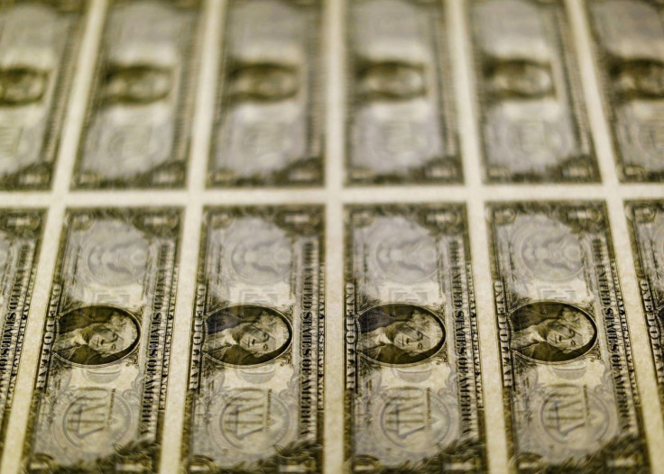 United States one dollar bills are seen on a light table at the Bureau of Engraving and Printing in Washington in this November 14, 2014, file photo. 