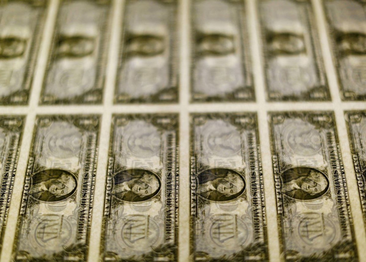 United States one dollar bills are seen on a light table at the Bureau of Engraving and Printing in Washington in this November 14, 2014, file photo.