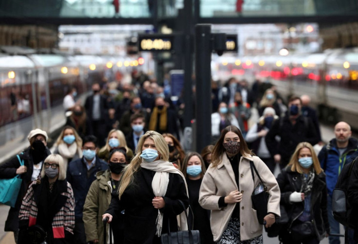 People walk along a platform at Kings Cross train station during morning rush hour, amid the coronavirus disease (COVID-19) outbreak in London, Britain, December 1, 2021. 