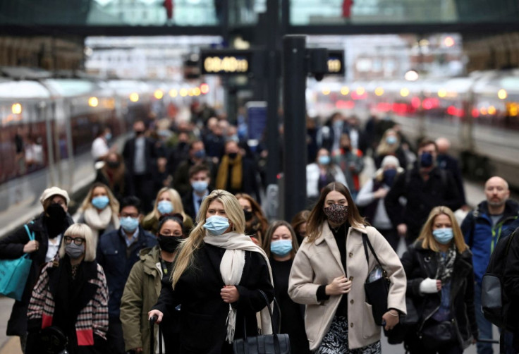People walk along a platform at Kings Cross train station during morning rush hour, amid the coronavirus disease (COVID-19) outbreak in London, Britain, December 1, 2021.
