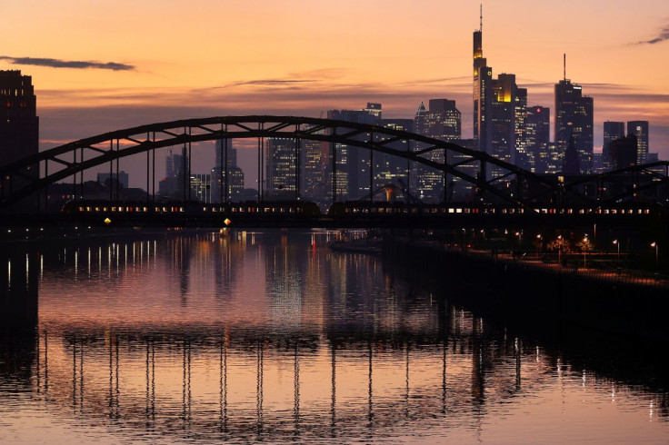 A commuter train passes by the skyline with its financial district in Frankfurt, Germany, October 25, 2021.