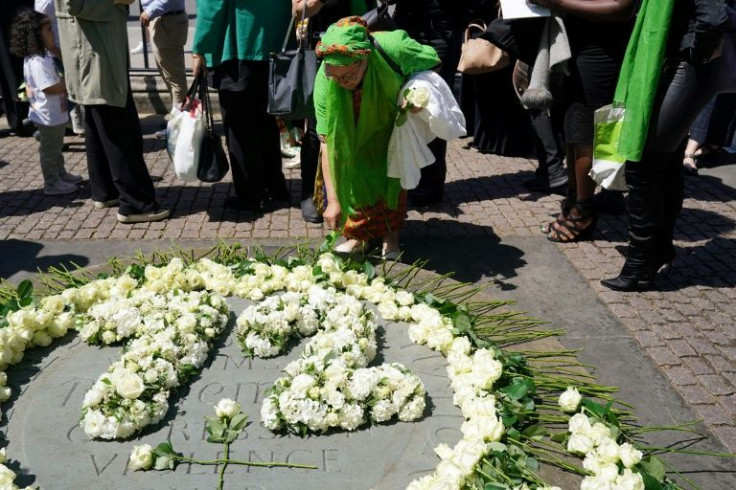People placed white roses in memory of the victims