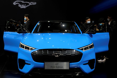 Visitors check on a Ford Mustang Mach-E electric vehicle displayed at a launch event in Shanghai, China April 13, 2021. 
