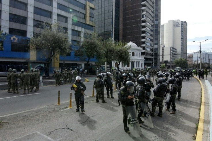 Soldiers and riot police stood guard outside the public prosecutor's office in the Ecuadoran capital Quito, where the president of the Confederation of Indigenous Nationalities in Ecuador (Conaie), Leonidas Iza, was being held