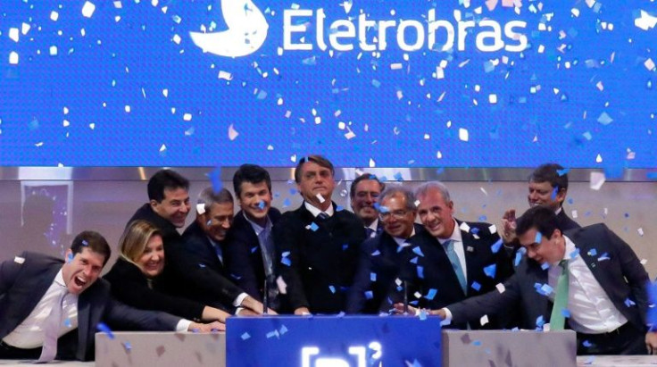 Brazil's President Jair Bolsonaro (C) ringing the bell at the Brazilian B3 Stock Exchange, in Sao Paulo, Brazil, on June 14 2022 to open trading on the newly privatized Electrobras company Brazilian President Jair Bolsonaro on Tuesday sealed the privati
